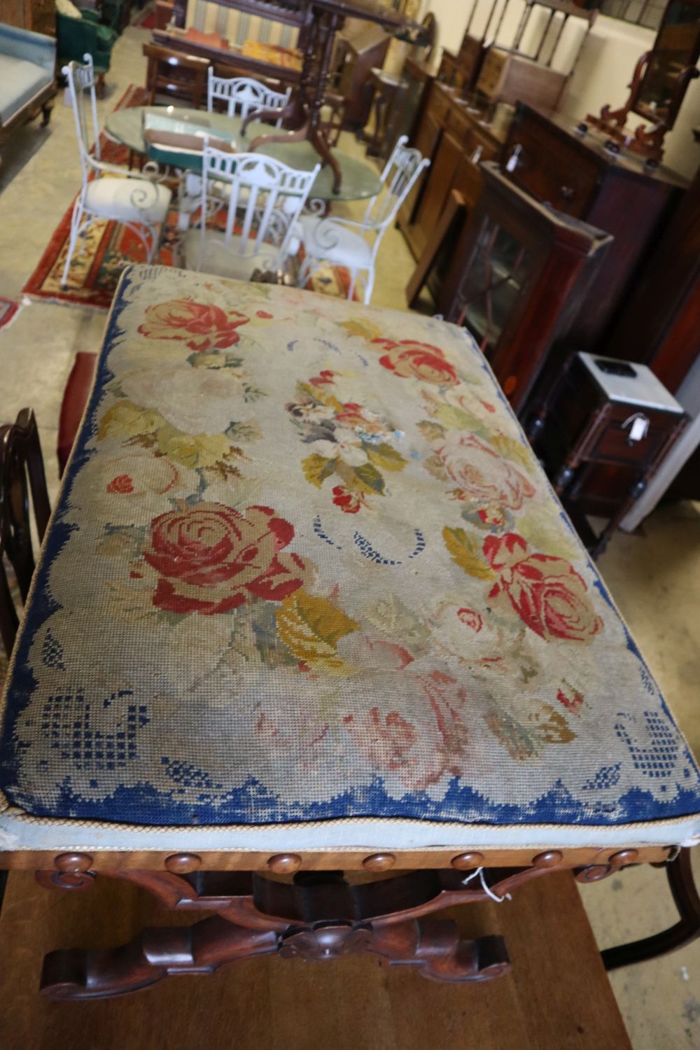 A William IV walnut X frame dressing stool with floral tapestry seat, width 100cm depth 65cm height 46cm